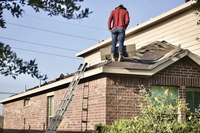 Professional roofer working on a residential roof in Barrett